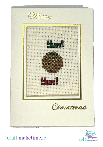 Cross-stitched Christmas card with a  Christmas pudding design and 'Merry Christmas' text.
