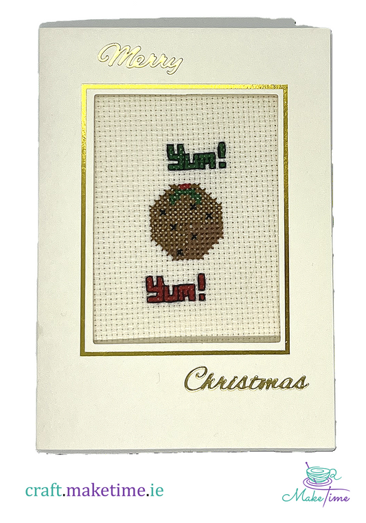 Cross-stitched Christmas card with a  Christmas pudding design and 'Merry Christmas' text.