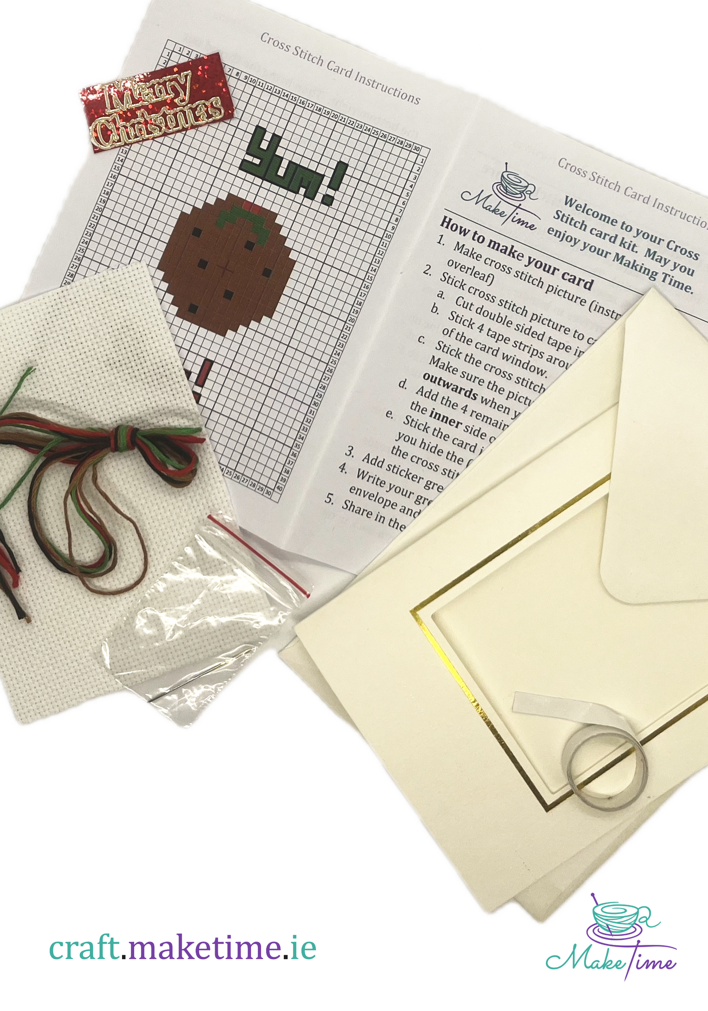 Christmas pudding craft kit with cross-stitch pattern, thread, and envelope on a white background