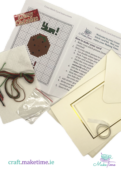 Christmas pudding craft kit with cross-stitch pattern, thread, and envelope on a white background