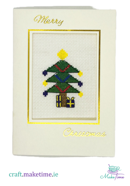 Cross-stitched Christmas tree on a card with 'Merry Christmas' text.