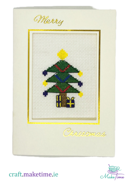 Cross-stitched Christmas tree on a card with 'Merry Christmas' text.